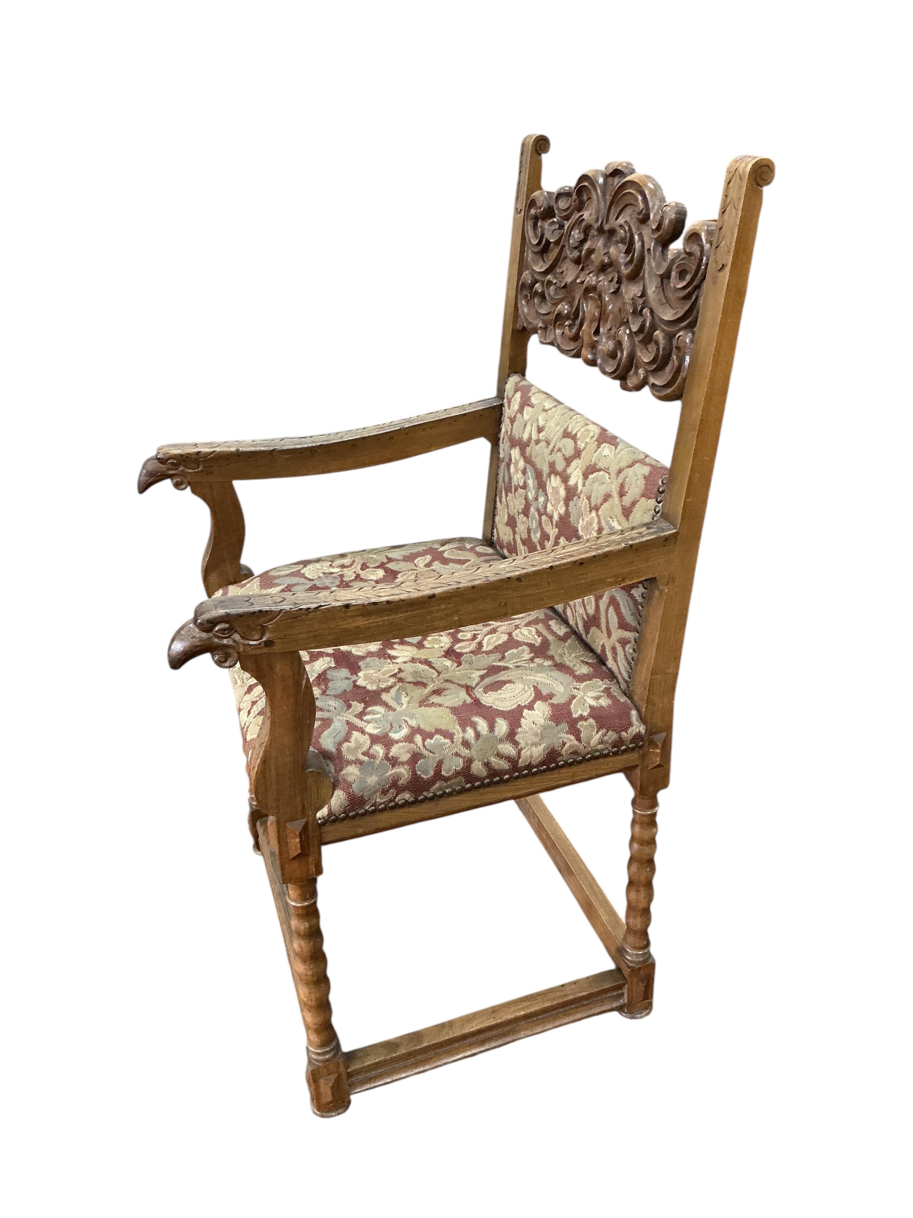An 18th century style carved walnut elbow chair, width 56cm, depth 54cm, height 111cm